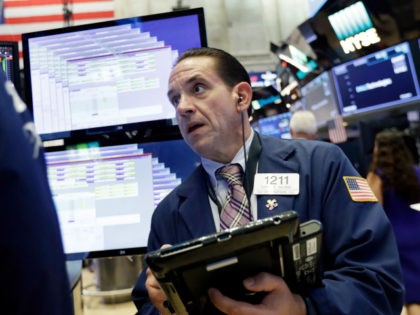 Trader Tommy Kalikas works on the floor of the New York Stock Exchange, Wednesday, July 18