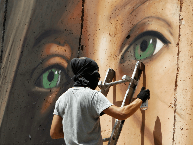 Italian artist Jorit Agoch paints a mural depicting jailed Palestinian teenager Ahed Tamim