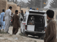 pakistan bomb People gather around an ambulance loaded with a dead body following a bomb blast at an election rally in Mastung on July 13, 2018. - A bomb killed at least 70 people and injured 40 others during a rally in Pakistan's restive Balochistan province, in the day's second attack on …