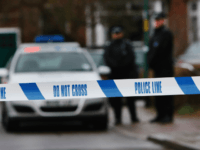 police london LONDON - DECEMBER 27: Police tape is pictured as police officers stand guard outside of a house in Edgeware on December 27, 2007 in London, England. A man is facing charges after a police officer was killed on duty after being called to a domestic row at an address in …