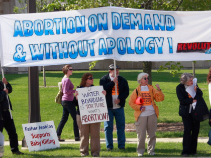 Demonstrators of both sides of the abortion debate compete for attention near the campus of Notre Dame University on May 17, 2009 in South Bend, Indiana. Activists from around the country have gathered in South Bend to protest or defend the university's decision to invite President Barack Obama, who supports …