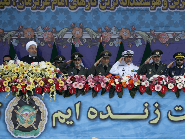 Iranian President Hassan Rouhani (L) and senior members of his armed forces watch a parade on the occasion of the country's annual army day on April 18, 2018, in Tehran. / AFP PHOTO / ATTA KENARE (Photo credit should read ATTA KENARE/AFP/Getty Images)