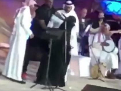 RIYADH, Saudi Arabia — A woman may face charges under a new harassment law in Saudi Arabia after storming a stage to hug a pop star, authorities and local media said Sunday.