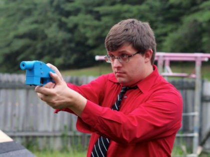Software engineer Travis Lerol takes aim with an unloaded Liberator handgun in the backyard of his home on July 11, 2013. The Liberator is the first gun that can be made entirely with parts from a 3D printer and computer-aided design (CAD) files downloaded from the Internet. AFP PHOTO / …
