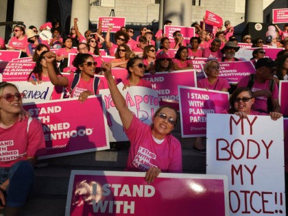 Supporters and patients of Planned Parenthood take part in a 'Pink the Night Out' rally at
