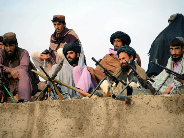 In this photograph taken on November 3, 2015, Afghan Taliban fighters listen to Mullah Moh