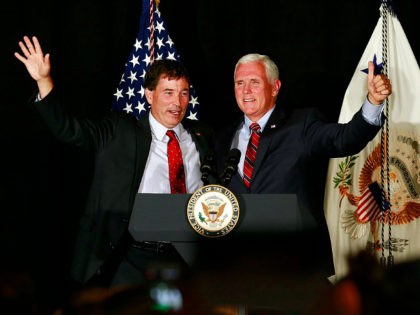 Vice President Mike Pence, right, waves to the crowd with 12th Congressional District Republican candidate Troy Balderson during a rally at "The Skylight" in Newark, Ohio, Monday, July 30, 2018. (Brooke LaValley/The Columbus Dispatch via AP)