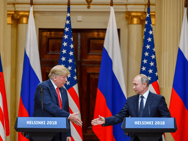US President Donald Trump (L) and Russia's President Vladimir Putin reach out to shake hands before attending a joint press conference after a meeting at the Presidential Palace in Helsinki, on July 16, 2018. - The US and Russian leaders opened an historic summit in Helsinki, with Donald Trump promising …