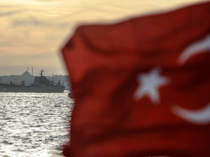 A Turkish flag flies on a ferry as Russian warship the BSF Saratov 150 sails through the B