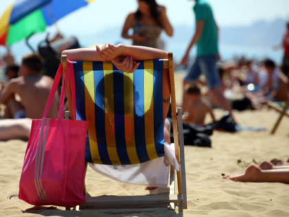 BOURNEMOUTH, UNITED KINGDOM - MAY 25: A sunbathers enjoys the sunshine on the beach on May