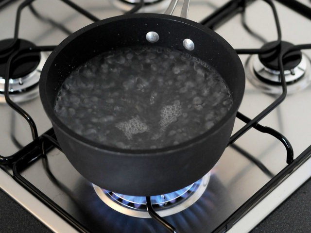 In this photo illustration water comes to the boil on a gas stove on January 8. 2009, in M