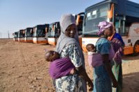 Nigerien migrants wait next to buses in Laghouat in northern Algeria as they are repatriated on June 29, 2018
