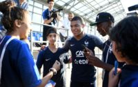 Young fans from Bondy took pictures with France star Kylian Mbappe after a training session in Russia