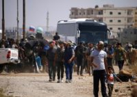 Hundreds of fighters and some relatives, carrying suitcases packed with clothes, boarded around 15 buses in Daraa city
