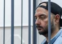 Russia's theatre and film director Kirill Serebrennikov, charged with fraud, standing inside a defendants' cage during a court hearing in Moscow on August 23, 2017