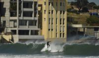 A surfer takes a wave on Bondi Beach in Sydney: plans to restrict surfing there have sparked anger