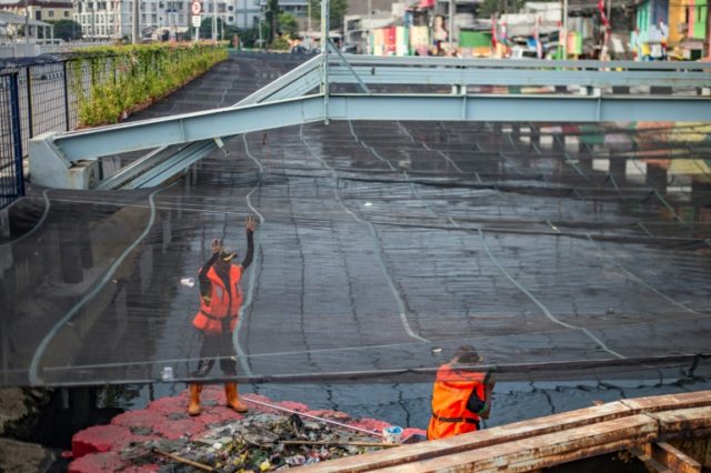 Jakarta covers up 'stinky, toxic' river near Asian Games village