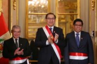 Vicente Zeballos (R), is sworn in as Peru's new justice minister as President Martin Vizcarra (C), and Prime Minister Cesar Villanueva applaud