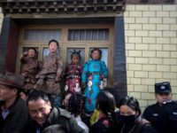 Children in traditional Tibetan clothes and police watch passing Tibetan Buddhist monks during a ceremony in March Children in traditional Tibetan clothes and police watch passing Tibetan Buddhist monks during a ceremony in March