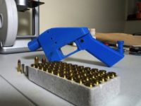 A Liberator pistol appears next to the 3D printer on which its components were made Trump 'looking into' rules on printed guns