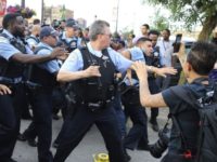 Police Shooting Chicago Members of the Chicago police department scuffle with an angry crowd at the scene of a police involved shooting in Chicago, on Saturday, July 14, 2018. (Nuccio DiNuzzo/Chicago Tribune via AP) Members of the Chicago police department scuffle with an angry crowd at the scene of a police involved shooting in Chicago, on Saturday, July 14, 2018. (Nuccio DiNuzzo/Chicago Tribune via AP)