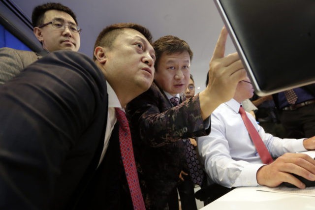 Financial Markets Wall Street Opera Limited IPO Yahui Zhou Opera Limited Chairman & CEO Yahui Zhou, third left, with secretary to the board An Da, left, and Shu Guan Wang, from China International Capital Corp., watch price quotes before Opera's IPO begins trading, at the Nasdaq MarketSite, in New York's Times Square, Friday, July 27, 2018. (AP Photo/Richard Drew) The Associated Press