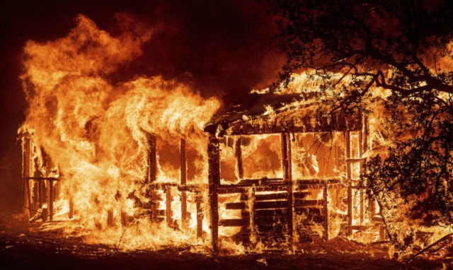 California Wildfires Urban Destruction In this Thursday, July 26, 2018 file photo, a structure burns as the Carr fire races along Highway 299 near Redding, Calif. In the last year, fires have devastated neighborhoods in the Northern California wine country city of Santa Rosa, the Southern California beach city of Ventura and, now, the inland city of Redding. Hotter weather from changing climates is drying out vegetation, creating more intense fires that spread quickly from rural areas to city subdivisions, climate and fire experts say. But they also blame cities for expanding into previously undeveloped areas susceptible to fire. AP Photo/Noah Berger, File) The Associated Press