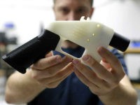 Cody Wilson, with Defense Distributed, holds a 3D-printed gun called the Liberator at his shop, Wednesday, Aug. 1, 2018, in Austin, Texas. A federal judge in Seattle issued a temporary restraining order Tuesday to stop the release of blueprints to make untraceable and undetectable 3D-printed plastic guns. (AP Photo/Eric Gay)