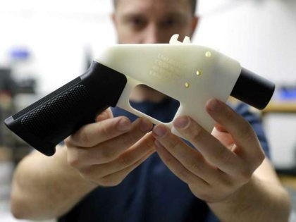 Cody Wilson, with Defense Distributed, holds a 3D-printed gun called the Liberator at his