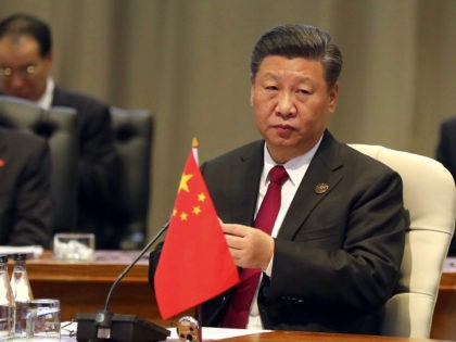 China's President Xi Jinping takes his seat for the first closed session of the BRICS summit, in Johannesburg, South Africa, Thursday, July 26, 2018. The five leaders of the BRICS emerging economies have gathered in South Africa for an annual summit where the United States is being criticized for escalating …