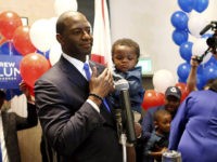 CORRECTION Florida Primary CORRECTS HIS SON'S NAME TO DAVIS, NOT JACKSON - Andrew Gillum holds his son Davis as he addresses his supporters after winning the Democrat primary for governor on Tuesday, Aug. 28, 2018, in Tallahassee, Fla. (AP Photo/Steve Cannon)