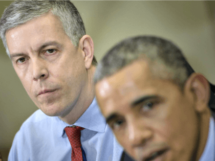 US Secretary of Education Arne Duncan (L) listens while US President Barack Obama makes a statement to the press after a meeting with the Council of the Great City Schools Leadership in the Roosevelt Room of the White House March 16, 2015 in Washington, DC. Obama spoke about the education …