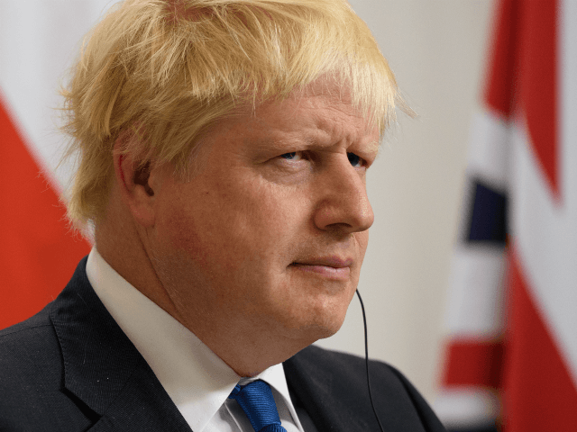 LONDON, ENGLAND - OCTOBER 12: Britain's Foreign Secretary Boris Johnson reacts to a commen