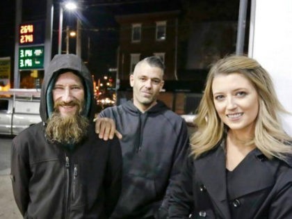 FILE- In this Nov. 17, 2017, photo, Johnny Bobbitt Jr., left, Kate McClure, right, and McClure's boyfriend Mark D'Amico pose at a Citgo station in Philadelphia. When McClure ran out of gas, Bobbitt, who is homeless, gave his last $20 to buy gas for her. McClure started a Gofundme.com campaign …