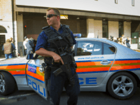 British police LONDON, ENGLAND - MAY 21: An armed police officer blocks the street as men charged with plotting the Hatton Garden jewellery heist arrive at Westminster Magistrates' Court on May 21, 2015 in London, England. Eight men, aged between 46 and 76, were charged with conspiracy to burgle following raids on …