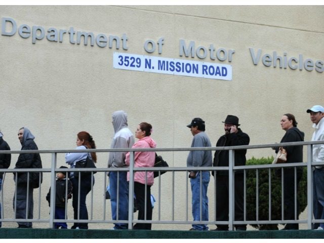 People wait in line outside of the State of California Department of Motor Vehicles (DMV) in Los Angeles, Califor