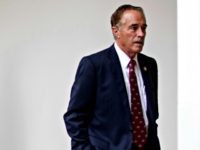 Rep. Chris Collins R-N.Y., walk through the colonnade from the West Wing into the White House in Washington, Friday, July 28, 2017.