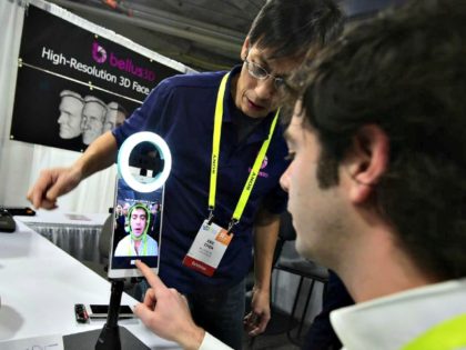 An attendee tries out the 3D face scanning device from Bellus 3D, a Silicon Valley startup working on next generation 3D face technology, on the showroom floor at the 2017 Consumer Electronics Show in Las Vegas, Nevada, Jan. 5, 2017. An attendee tries out the 3D face scanning device from …