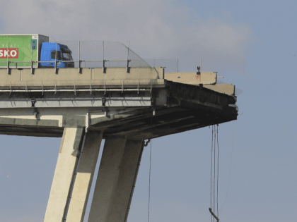 A lorry sits on the Morandi motorway bridge after it collapsed in Genoa on August 14, 2018. - At least 30 people were killed on August 14 when the giant motorway bridge collapsed in Genoa in northwestern Italy. The collapse of the viaduct, which saw a vast stretch of the …