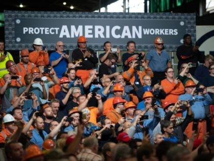 Workers listen as US President Donald Trump speaks about trade at US Steel's Granite