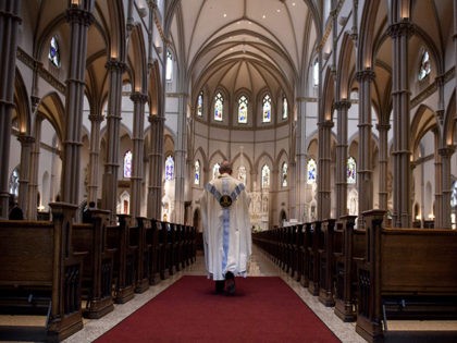 PITTSBURGH, PA - AUGUST 15: Father Kris Stubna walks to the sanctuary following a mass to celebrate the Assumption of the Blessed Virgin Mary at St Paul Cathedral, the mother church of the Pittsburgh Diocese on August 15, 2018 in Pittsburgh, Pennsylvania. The Pittsburgh Diocese was rocked by revelations of …