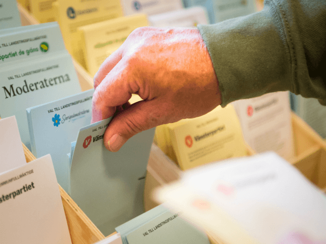 person picks ballot papers to vote in advance at a polling station in Stockholm, Sweden, o