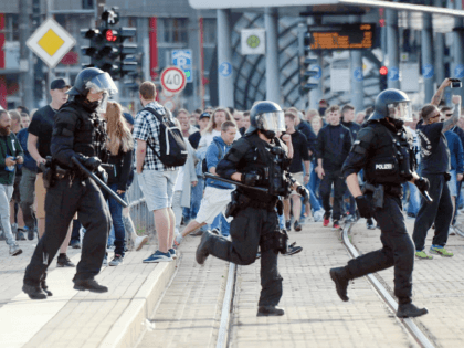 Riot police cross the street as a city festival was cancelled on August 26, 2018 in Chemni