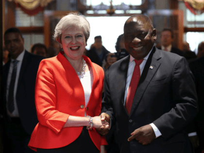 Britain's Prime Minister Theresa May is greeted by South African President Cyril Ramaphosa in Cape Town on August 28, 2018 as part of a working visit to South Africa. (Photo by MIKE HUTCHINGS / POOL / AFP) (Photo credit should read MIKE HUTCHINGS/AFP/Getty Images)