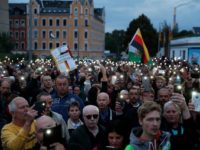 The far-right group "Pro Chemnitz" stage a protest at the entrance to the stadium of Chemnitz FC, where Minister President of Saxony, Michael Kretschmer will meet with members of the public on August 30, 2018 amid tensions sparked by a deadly stabbing in Chemnitz, eastern Germany. - After the fatal …