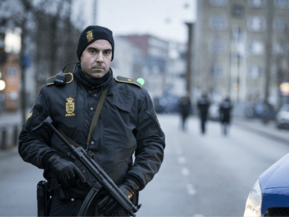 A police officer guards the street around the Noerrebro train station in Copenhagen on Feb
