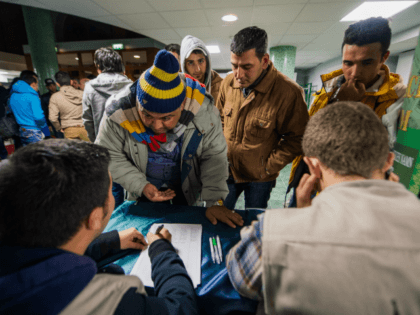 Refugee's register their names as they arrive to Stockholm central mosque on October 15, 2015 after many hours bus journey from the southern city of Malmo. Since September, Islamic Relief Sweden welcomes newly arrived refugees at the Stockholm central mosque for one or two nights before they seek asylum in …