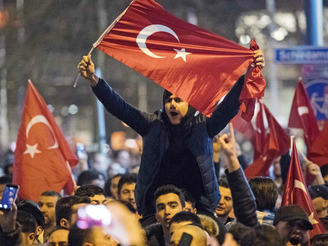People wave Turkish national flags during a demostration near the Turkish consulate in Rotterdam on March 11, 2017 after the Turkish Family Minister was barred by police from entering the Turkish consulate and escorted out of the country. Turkey's Family Minister Fatma Betul Sayan Kaya was back in Istanbul after …
