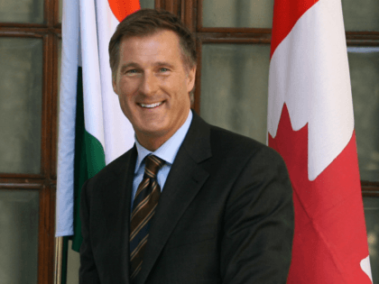 Minister of Foreign Affairs of Canada Maxime Bernier (R) shakes hands with Indian Minister