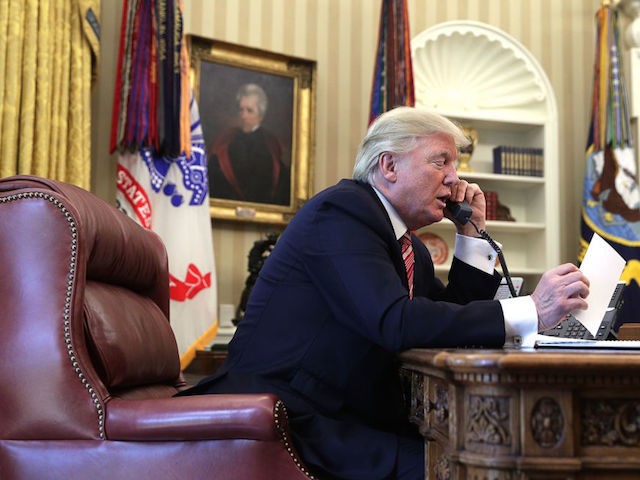 U.S. President Donald Trump speaks on the phone (Photo by Alex Wong/Getty Images)